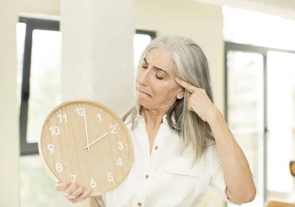 senior woman with a clock