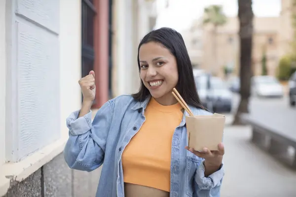 hispanic pretty woman with an asian noodles bowl