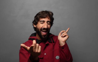 Gülümsüyor, kaygısız hissediyor, rahat ve mutlu, dans ediyor ve müzik dinliyor, bir partide eğleniyor.