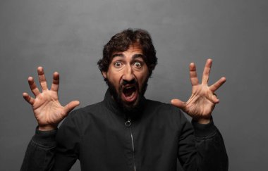 Panik içinde ya da öfkeyle bağırıyordu. Şok olmuş, korkmuş ya da öfkeli, elleri başının yanındaydı.