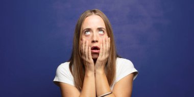 Şok olmuş ve korkmuş hissediyorum, yanaklarındaki ellerden sıkılmış gibiyim.