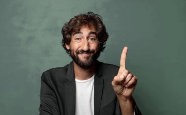  Gururla ve kendinden emin bir şekilde gülümseyerek bir numaralı pozu vererek, bir lider gibi hissederek.