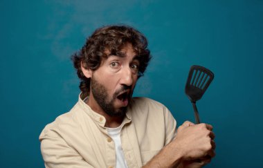 Genç yetişkin sakallı adam yemek pişirme konsepti