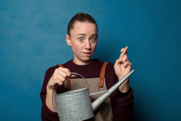 crossing fingers anxiously and hoping for good luck with a worried look