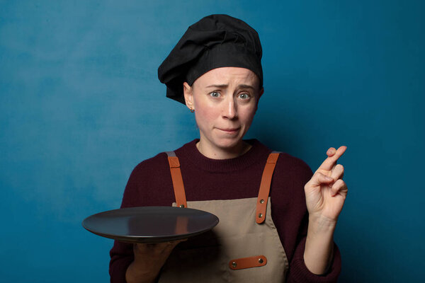 blonde young pretty chef woman with an empty dish