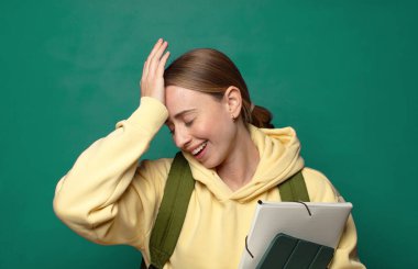 laughing and slapping forehead like saying doh I forgot or that was a stupid mistake