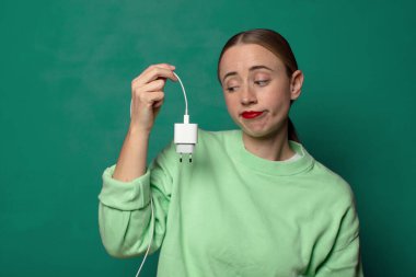 Akıllı telefon şarj aleti olan genç sarışın kadın.