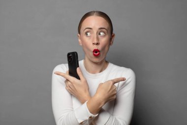 Şaşırmış ve kafası karışmış görünüyor, güvensiz ve şüpheyle zıt yönleri işaret ediyor.