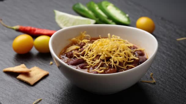 Shredded Cheddar Cheese Falling Cup Chili — Stock video