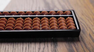 Traditional Japanese abacus with wooden frame and plastic bids.