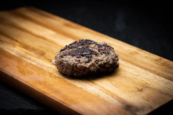 Grilled round sausage on a wooden table