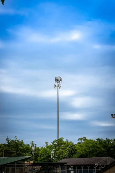蓝天背景下的手机中继器塔 — 图库照片