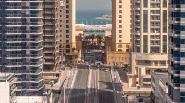 Tüm gün boyunca JBR caddesinin kavşağında yoğun trafik olan hava manzarası. Jumeirah Sahili İkamet Bölgesi ve Dubai Marina Yukarıdan hızla hareket ediyor