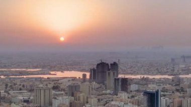 Sunrise with the city scape of Ajman from roof airial time apse. Modern şehrin üzerinde güneş. Ajman, Birleşik Arap Emirlikleri 'nde Ajman Emirliğinin başkentidir..
