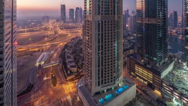道路の交差点や日移行タイムラプスに都会の夜に近代的な塔の空撮 車と高層ビルとアラブ首長国連邦のドバイのマリーナ地区の都市景観 — ストック動画