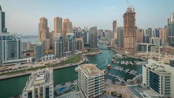 stock image Panorama showing Dubai Marina with several boat and yachts parked in harbor and skyscrapers around canal aerial timelapse. Towers of JBR district on a background