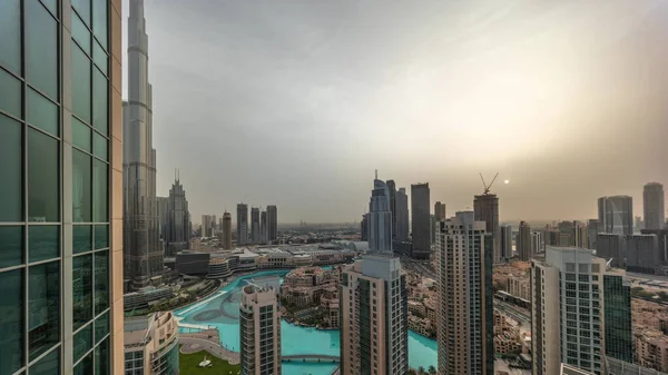 Dubai downtown during sunrise with fountains and modern futuristic architecture aerial timelapse. Panoramic view to skyscrapers with old town and shopping mall