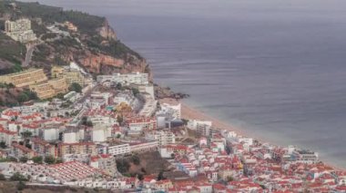 Atlantik Okyanusu 'nun ortasındaki Susimbra Köyü' nün kıyı şeridinin hava görüntüsü. Kale 'nin bakış açısından aydınlatılmış evlerle dolu bir akşam. Portekiz