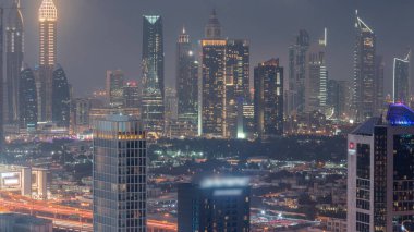Rows of skyscrapers in financial district of Dubai aerial day to night transition . Panoramic view to many towers from Business bay district