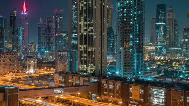 Earth hour with lights turning off and on. Towers around Sheikh Zayed Road and DIFC district aerial with and without night illumination  in Dubai, UAE. International Financial Centre skyscrapers