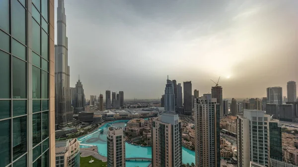Dubai downtown during sunrise with fountains and modern futuristic architecture aerial . Panoramic view to skyscrapers with old town and shopping mall