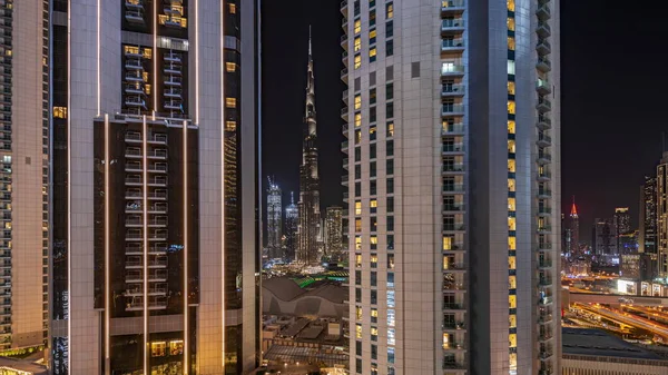 Panorama showing tallest skyscrapers during Earth hour in downtown dubai located on bouleward street near shopping mall aerial night . Lights turning off for one hour