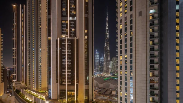 Panorama showing tallest skyscrapers during Earth hour in downtown dubai located on bouleward street near shopping mall aerial night . Lights and illumination turning on after one hour