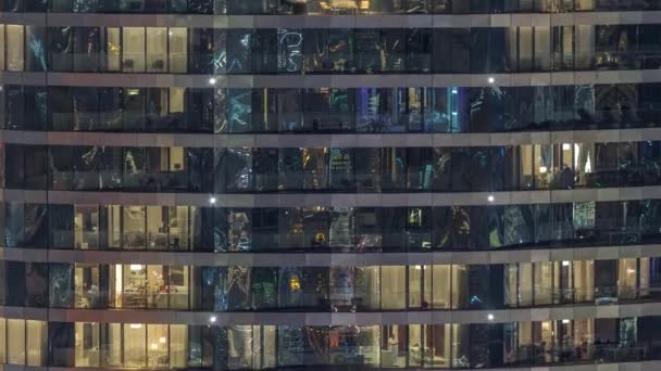 夜のタイムラプスで高級ビルのアパートの窓の外の景色 超高層ビルのライトを反射で照らす — ストック動画