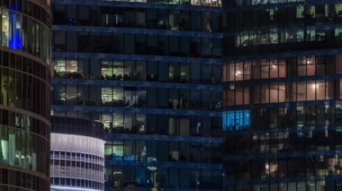 Close up view to glowing office windows in Skyscrapers International Business Center of City at night timelapse from top