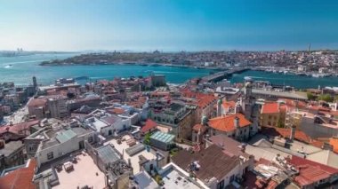 The view from Galata Tower to Galata Bridge panoramic timelapse which is connected Beyoglu region and Sultanahmet on the opposite shores of Golden Horn, Istanbul, Turkey. Ferries traffic at sunny