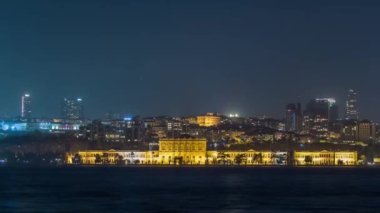 Illuminated Mimar Sinan University night timelapse. View to besiktas district in Istanbul taken from asian part of the city. Reflection on Bosphorus water