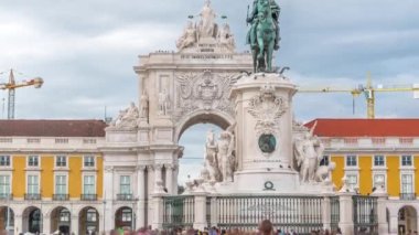 Triumphal arch at Rua Augusta and bronze horse statue of King Jose I at Commerce square timelapse in Lisbon, Portugal. Cloudy sky on a background