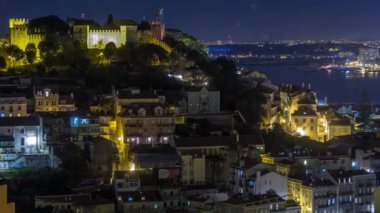 Lisbon aerial overview of city centre with illuminated castle on hill at Autumn night timelapse, Portugal. Top view from Miradouro da Nossa Senhora do Monte viewpoint