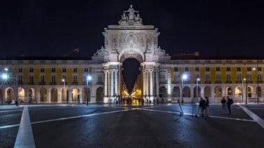 Triumphal arch at Rua Augusta at Commerce square illuminated at night timelapse hyperlapse in Lisbon, Portugal. People walking around