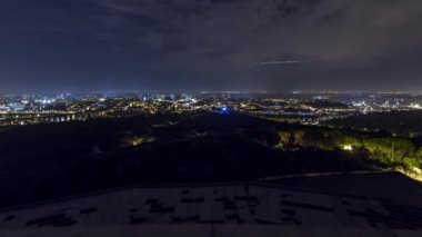 Panoramic overview of Lisbon and Almada from a viewpoint in Monsanto night timelapse. Aerial top view with traffic on illumitated city streets