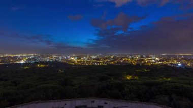 Panoramic dawn view over Lisbon and Almada from a viewpoint in Monsanto night to day transition timelapse. Aerial top overview with traffic on city streets