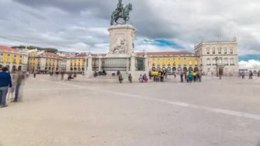 Bronze statue of King Jose I and triumphal arch at Rua Augusta at Commerce square timelapse hyperlapse in Lisbon, Portugal. Cloudy sky. Walking area