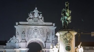 Triumphal arch at Rua Augusta and bronze statue of King Jose I at Commerce square illuminated at night timelapse in Lisbon, Portugal.