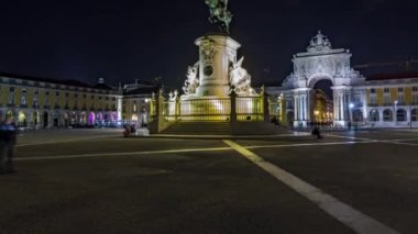 Triumphal arch at Rua Augusta and illuminated bronze statue of King Jose I at Commerce square lited at night timelapse hyperlapse in Lisbon, Portugal.