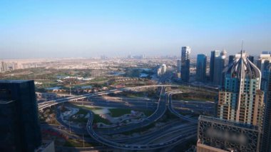 Aerial top view of busy traffic on Dubai highway urban and modern transportration concept. Cars driving on junction and overpass in Dubai Marina