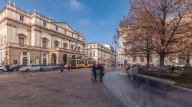 Panorama showing theater La Scala timelapse and a small park opposite to historic building with a monument to Leonardo da Vinci and his students. People walking around and sitting on a bench