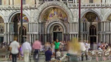 Entrance to Basilica of St Mark night timelapse. It is cathedral church of Roman Catholic Archdiocese of Venice. It located at Piazza San Marco. Tourists walking in front of it. Venice, Italy