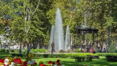 Fountains in Zrinjevac, one of the oldest parks in city timelapse. Zagreb, Croatia. People sitting around and making photos
