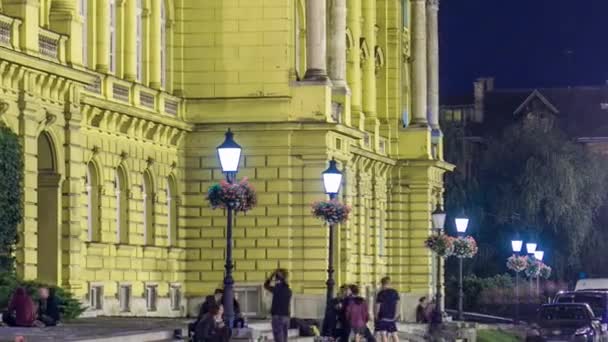 Building Croatian National Theater Illuminated Night Timelapse People Sitting Bench — Stockvideo