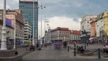 Central city square Trg bana Jelacica timelapse hyperlapse and Ban Jelacic monument in Zagreb, Croatia. The oldest standing buildings and blue trams passing by