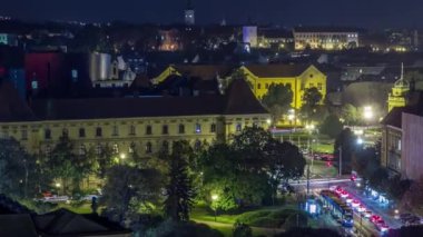 Panorama of the city center night timelapse shoot from top of skyscraper with aerial view to the intersection in front of national theater and museum in Zagreb, Croatia. Traffic on the road