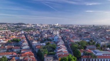 Panoramic aerial view over Rooftops of Portos old town on a warm spring day timelapse before sunset time with cloudy sky, Porto, Portugal