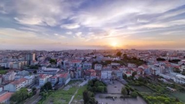 Panoramic aerial view over Rooftops of Portos old town on a warm spring evening timelapse during sunset time with cloudy colorful sky, Porto, Portugal
