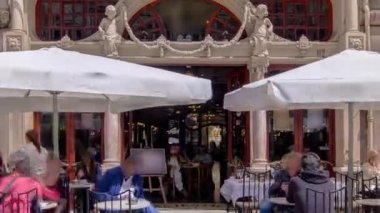 Porto Portekiz 'deki Majestic Cafe cephesinde. İnsanlar dışarıda şemsiyelerin altında oturuyor.