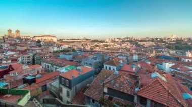 Sunset time, shadow covering Douro riverside with the Dom Luiz bridge and Mosteiro da Serra do Pilar, Porto aerial panoramic timelapse, Portugal. Warm evening light
